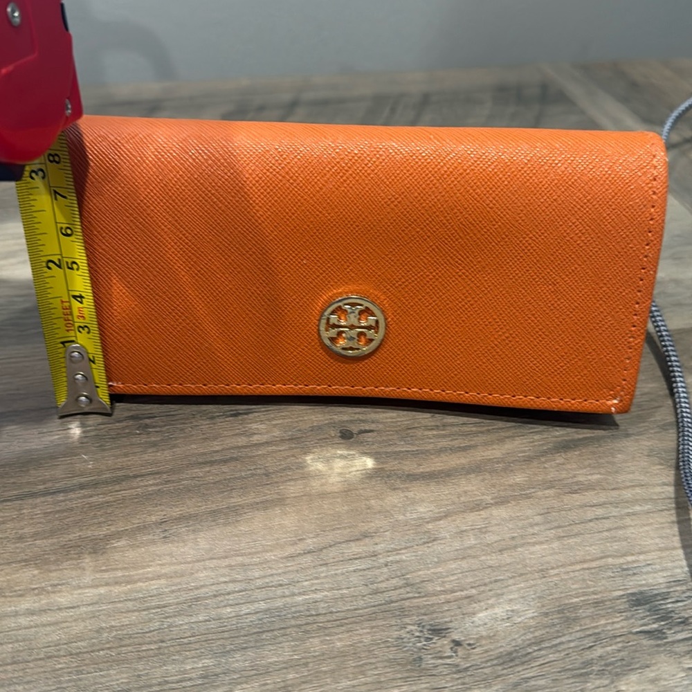 Tory Burch orange sunglasses case with matching cloth.
